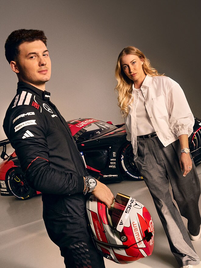 Hannah Schönwald and Fabian Schiller in front of an AMG touring car