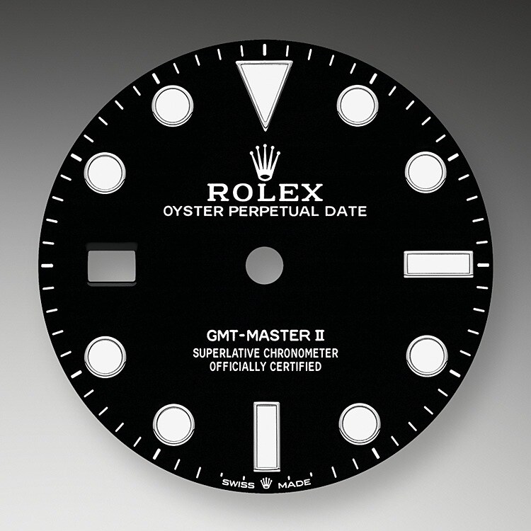 <p>Die GMT‑Master II lässt sich unter allen Einsatzbedingungen, vor allem im Dunklen, sehr gut ablesen dank ihrer Chromalight-Anzeige, deren groß bemessene Indizes und breite Zeiger in einfachen Formen – Dreiecke, Kreise und Rechtecke – mit einer lange nachleuchtenden Leuchtmasse beschichtet sind.</p> <p>Bei dieser Neuinterpretation sind die Aufzugskrone sowie der Kronenschutz an die linke Seite des Gehäuses versetzt. Das Datumsfenster mit der Zykloplupe erscheint auf der 9‑Uhr‑Position.</p>