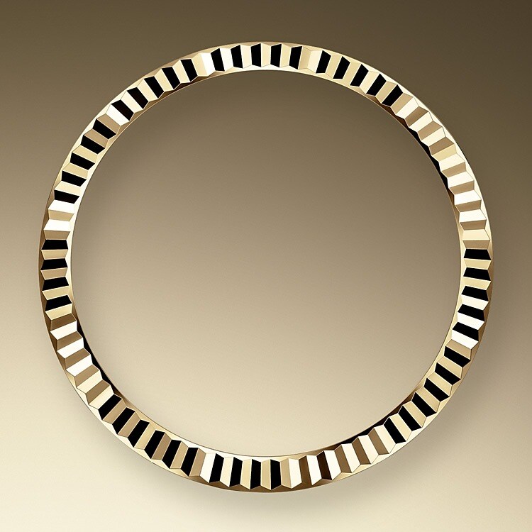 The Rolex fluted bezel is a mark of distinction. Originally, the fluting of the Oyster bezel had a functional purpose: it served to screw the bezel onto the case helping to ensure the waterproofness of the watch. It was therefore identical to the fluting on the case back, which was also screwed onto the case for waterproofness, using specific Rolex tools. Over time, the fluting became an aesthetic element, a genuine Rolex signature feature. Today the fluted bezel is a mark of distinction, in gold on this Datejust 31.