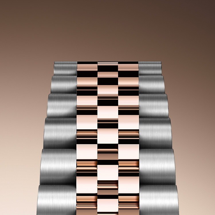 Bei Design, Entwicklung und Produktion der Armbänder und Schließen von Rolex sowie bei der rigorosen Qualitätsprüfung, der sie unterzogen werden, kommen hochtechnologische Verfahren zum Tragen. Und wie alle Bestandteile der Armbanduhr werden auch diese Komponenten Sichtkontrollen unterzogen, bei denen das menschliche Auge alle ästhetischen Merkmale genau überprüft, um makellose Schönheit zu gewährleisten. Das Jubilee-Band, ein fünfreihiges Metallarmband mit fließenden Konturen und hohem Tragekomfort, wurde eigens für die Einführung des Modells Oyster Perpetual Datejust im Jahre 1945 entwickelt.