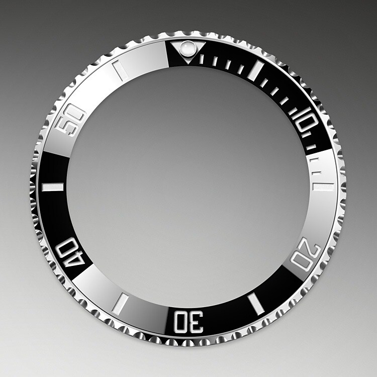 The Submariner's rotatable bezel is a key functionality of the watch. Its 60-minute graduations allow a diver to accurately and safely monitor diving time and decompression stops. Manufactured by Rolex from a hard, corrosion-resistant ceramic, the Cerachrom bezel insert is virtually scratchproof. A luminescent capsule on the zero marker ensures legibility, no matter how dark the environment. The bezel’s knurled edge is carefully designed to offer excellent grip under water, even with gloves.