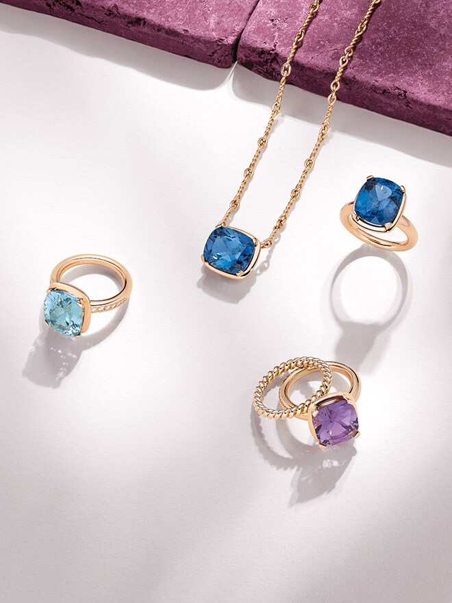 Vier Ringe und ein Anhänger der Linie Daily Heritage BY KIM mit unterschiedlichen Farbedelsteinen