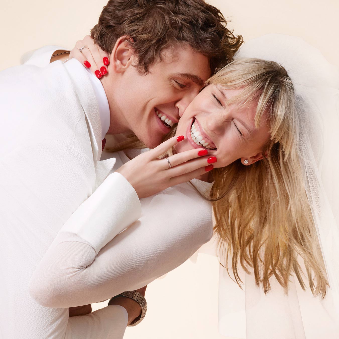 A laughing bride and groom hugging each other A laughing bride and groom hugging each other