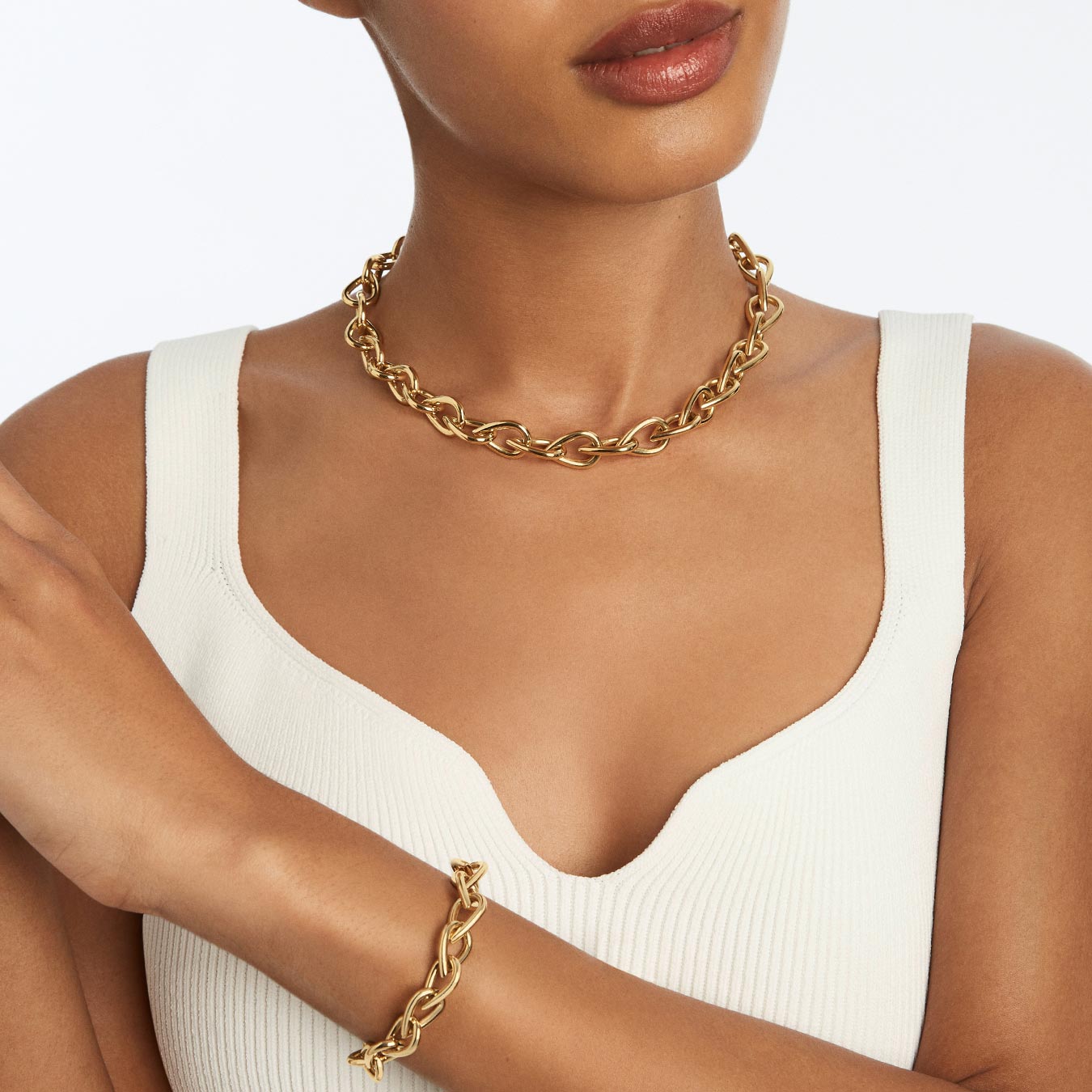 Woman in a white top wears an Uptown by Wempe Statements necklace and bracelet Woman in a white top wears an Uptown by Wempe Statements necklace and bracelet