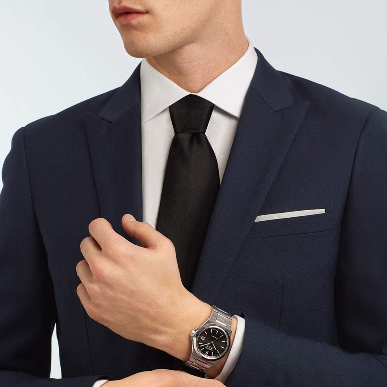 Man in a dark blue suit wears the Wempe Glashütte i/SA Iron Walker Automatic with black dial Man in a dark blue suit wears the Wempe Glashütte i/SA Iron Walker Automatic with black dial