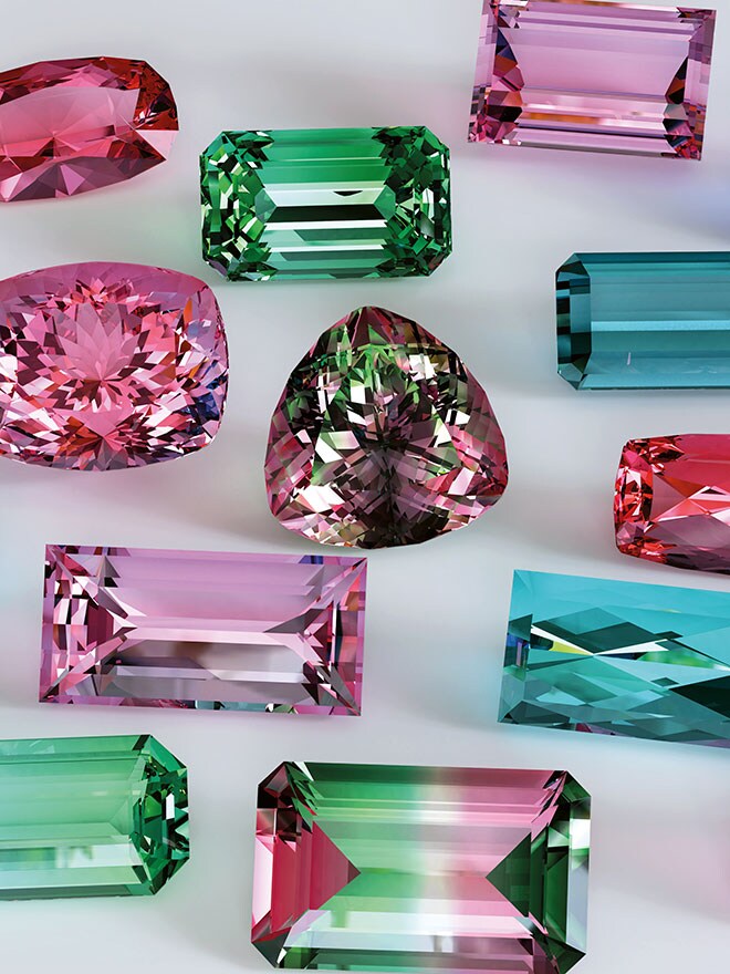 Edelsteine in verschiedenen Farben und Schliffen auf einem grauen Hintergrund 